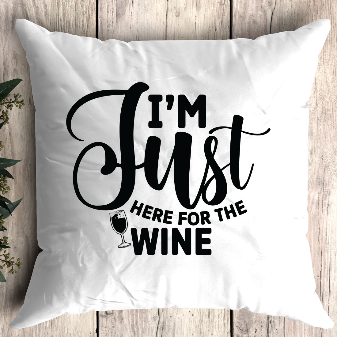 Pillow that says i'm just here for the wine.