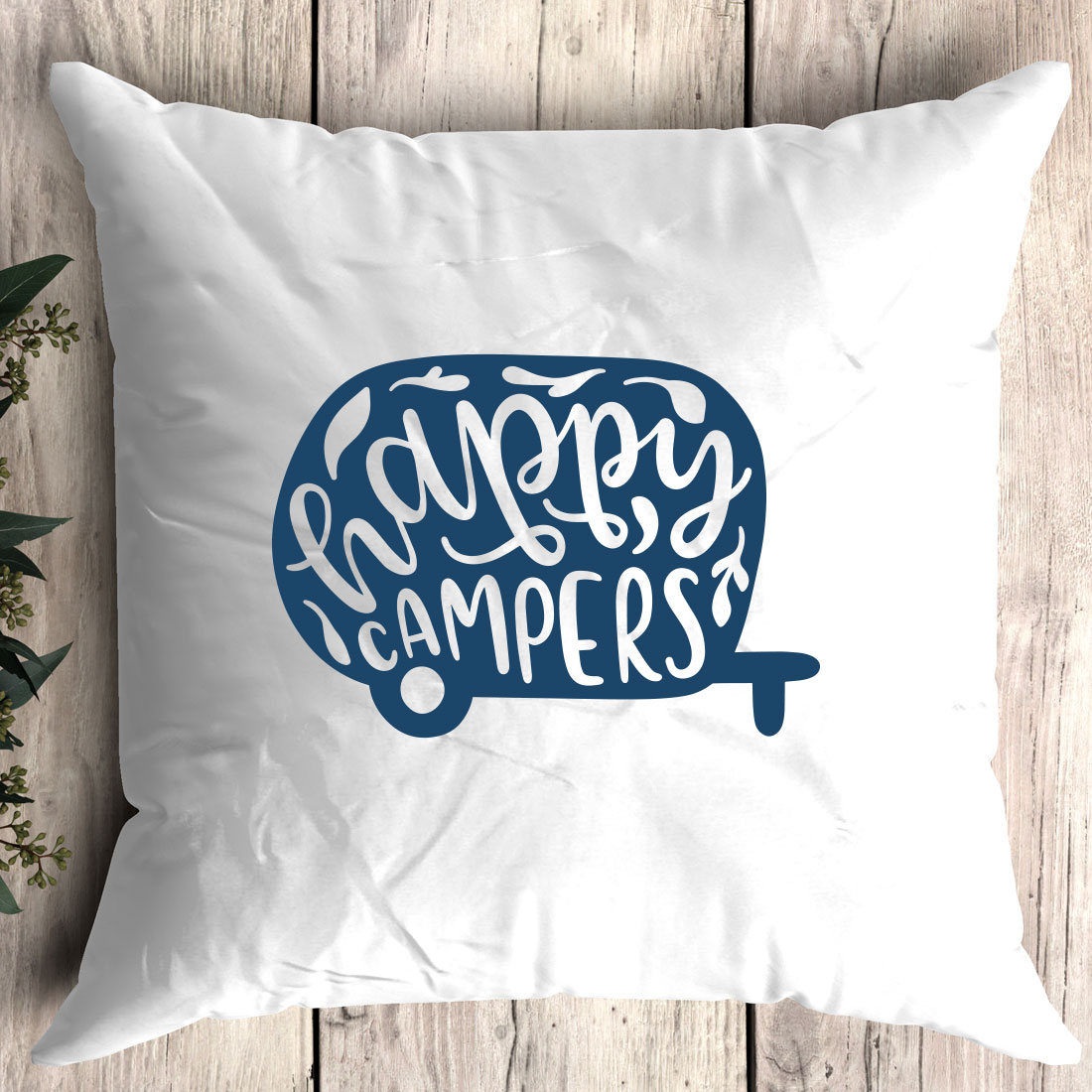 Pillow with the words happy campers printed on it.