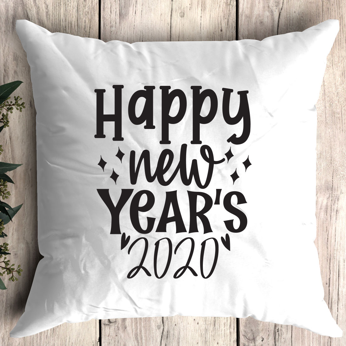 White pillow with the words happy new year's written on it.