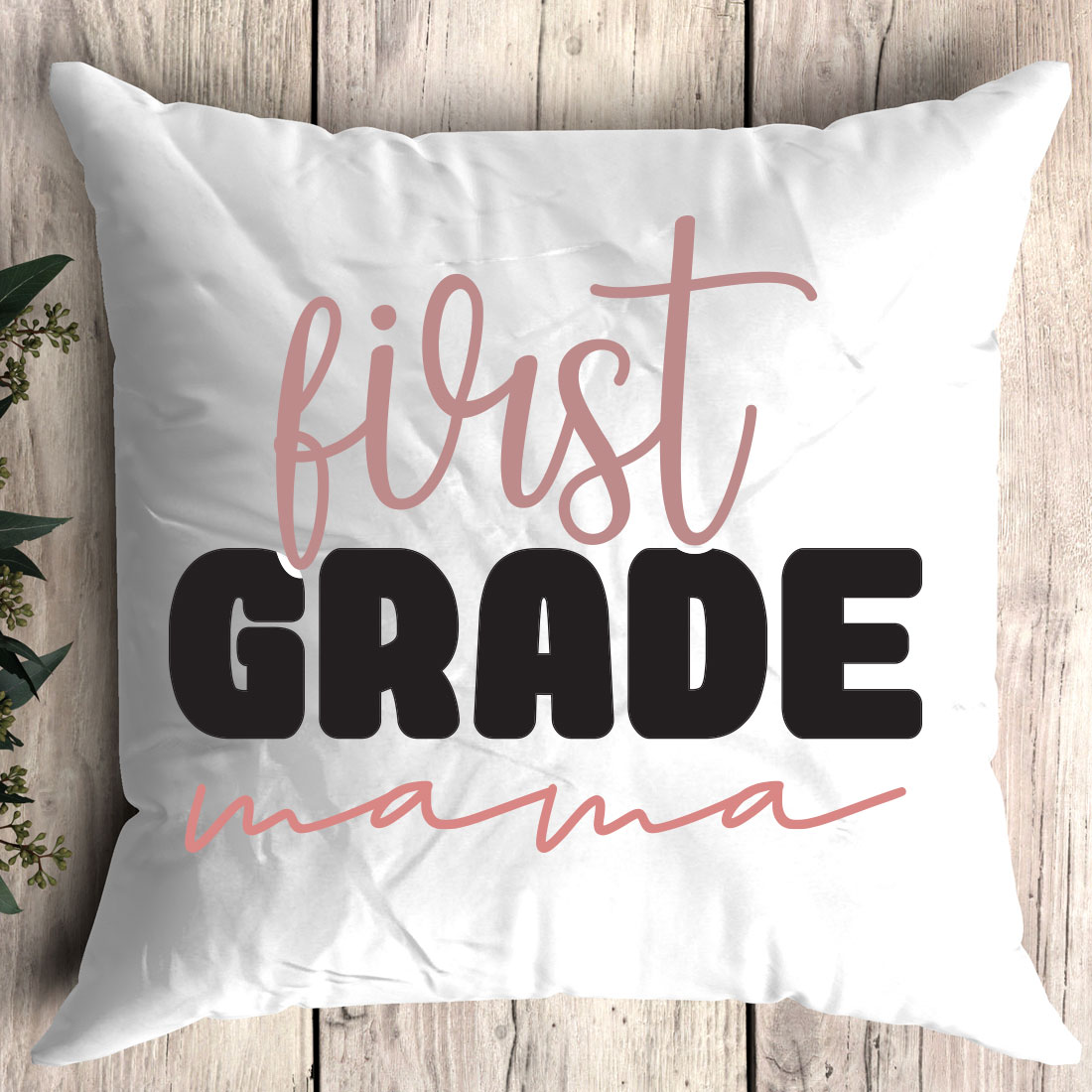 Pillow that says first grade mama on it.