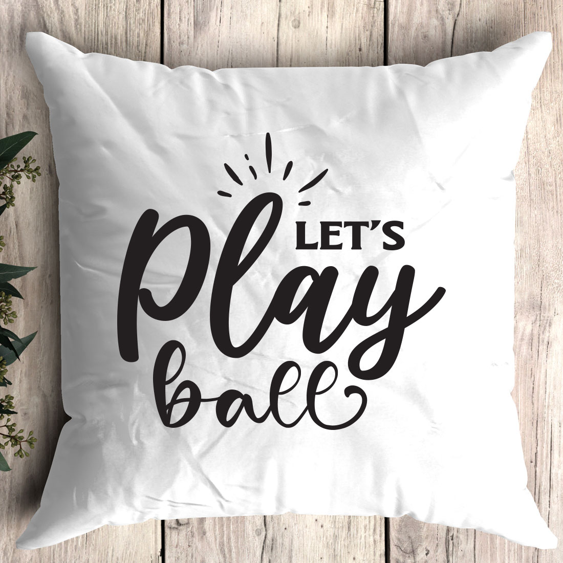 Pillow that says let's play ball on it.