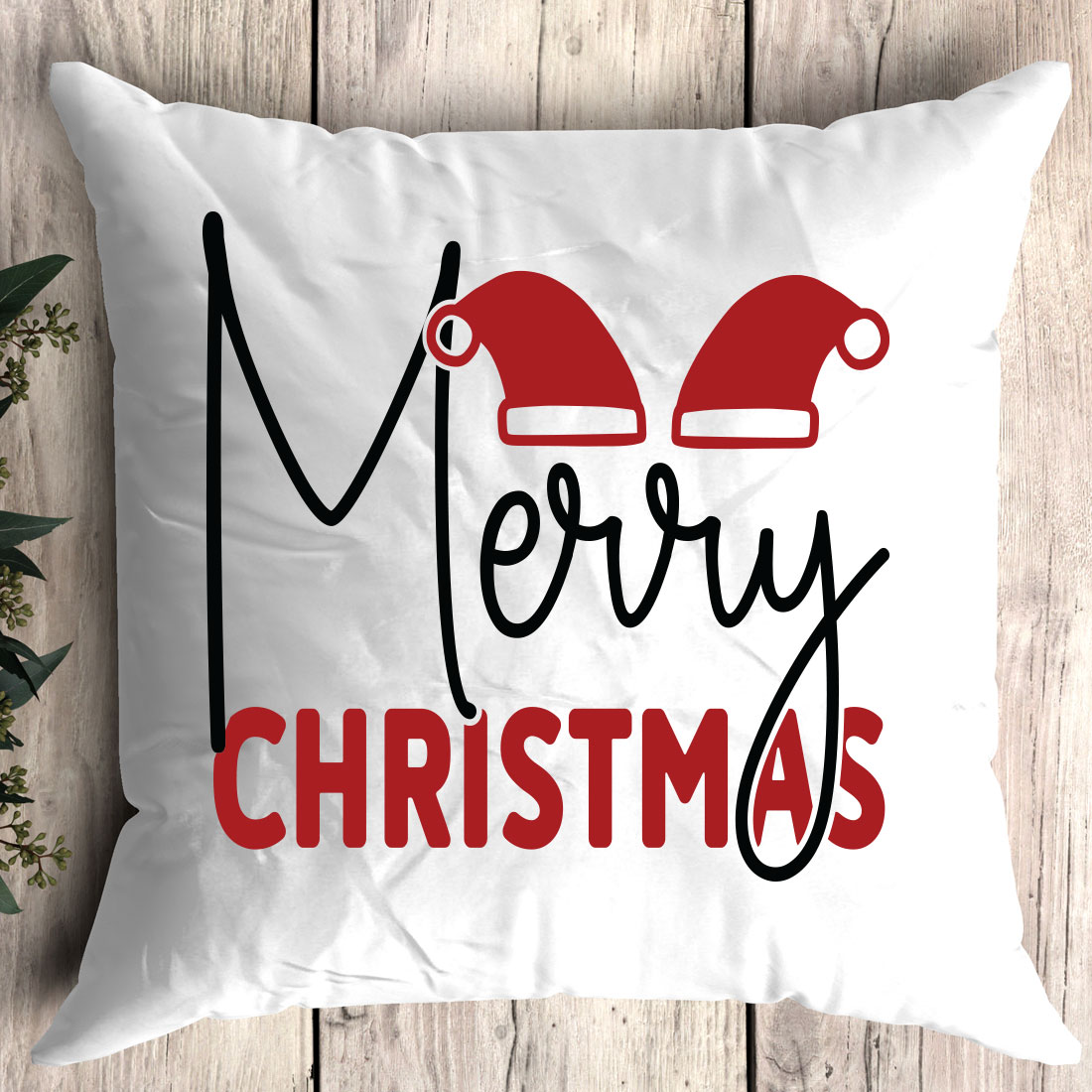 White pillow with a merry christmas design on it.