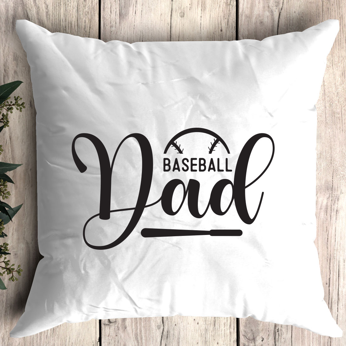 Baseball dad pillow sitting on top of a wooden floor.