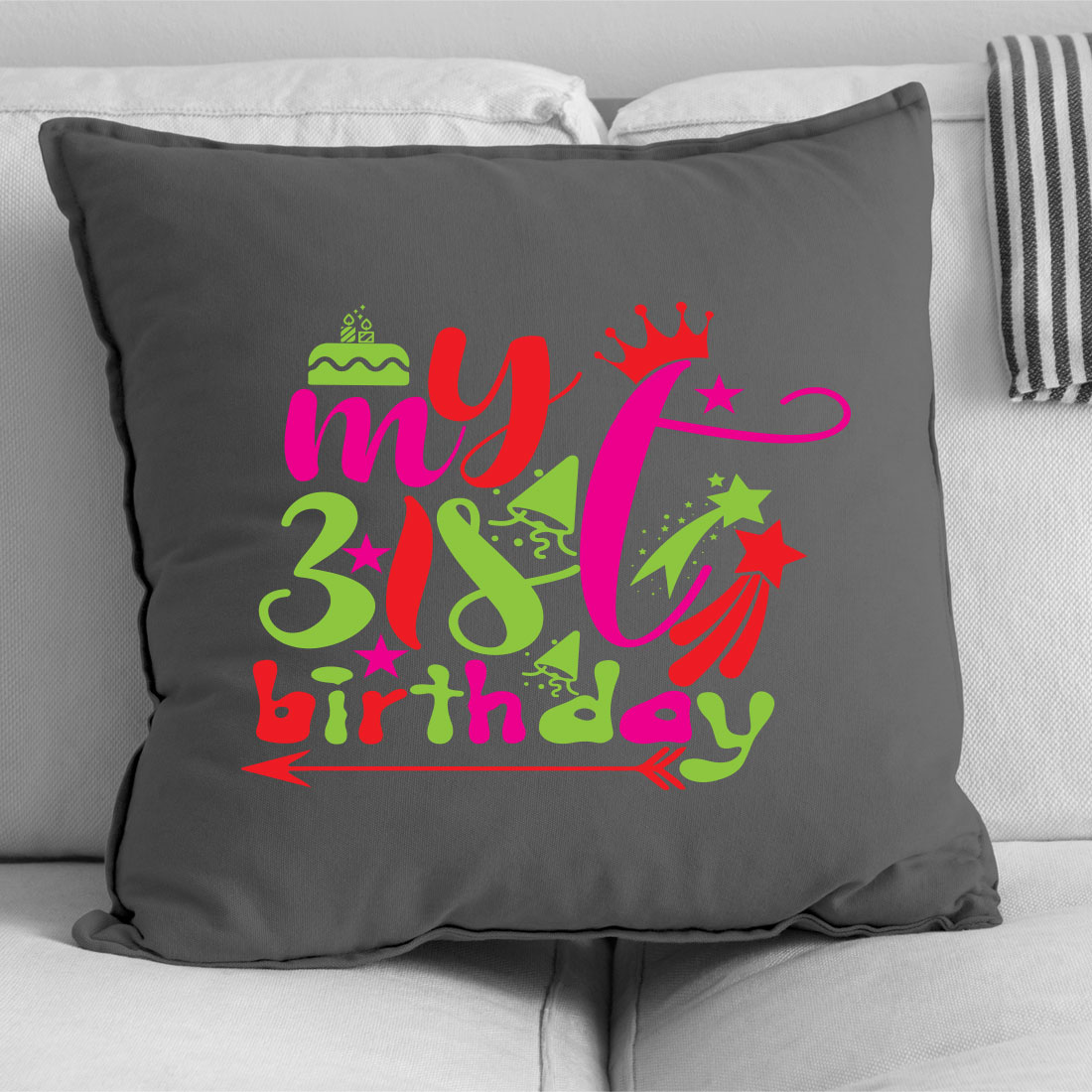 Gray pillow with a pink and green design on it.