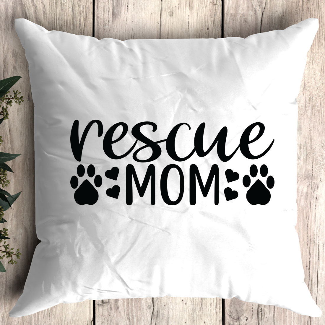 Pillow that says rescue mom with paw prints.