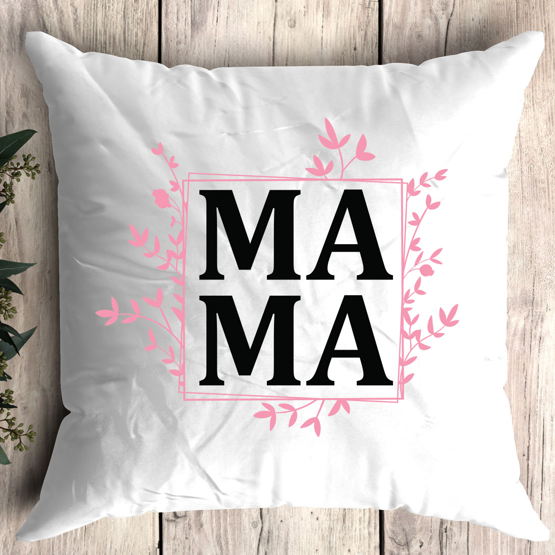 White pillow with the word ma on it.