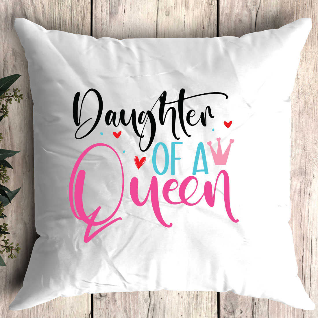 White pillow with the words daughter of a queen printed on it.