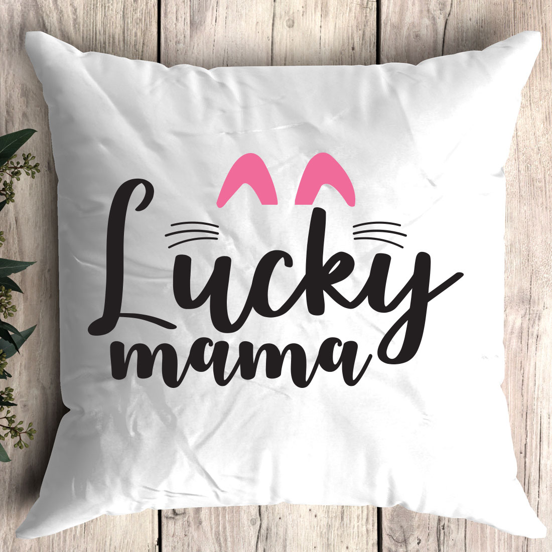 White pillow with the words lucky mama printed on it.