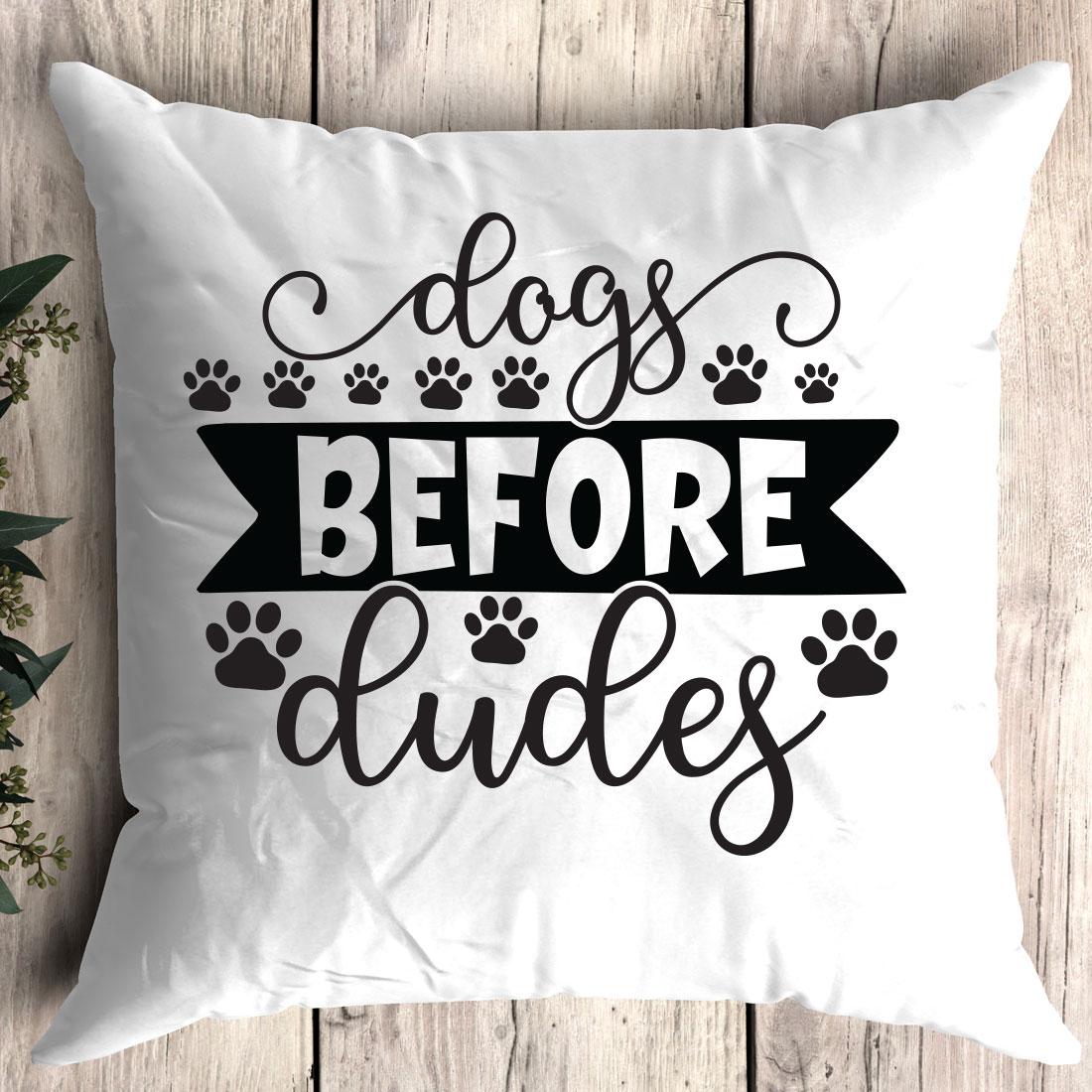 Pillow that says dogs before dudes on it.