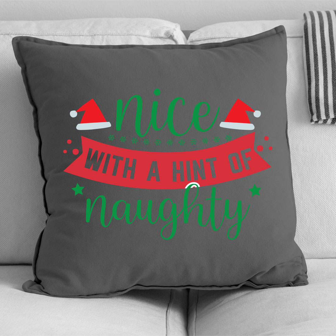 Gray pillow with a red and green ribbon on it.