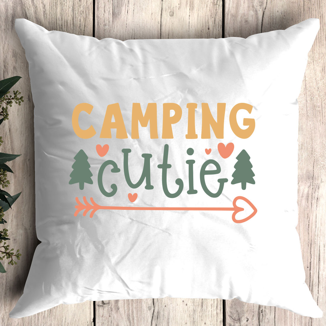 White pillow with the words camping cutie on it.