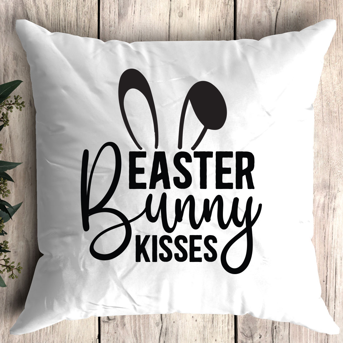 White pillow with the words easter bunny kisses on it.