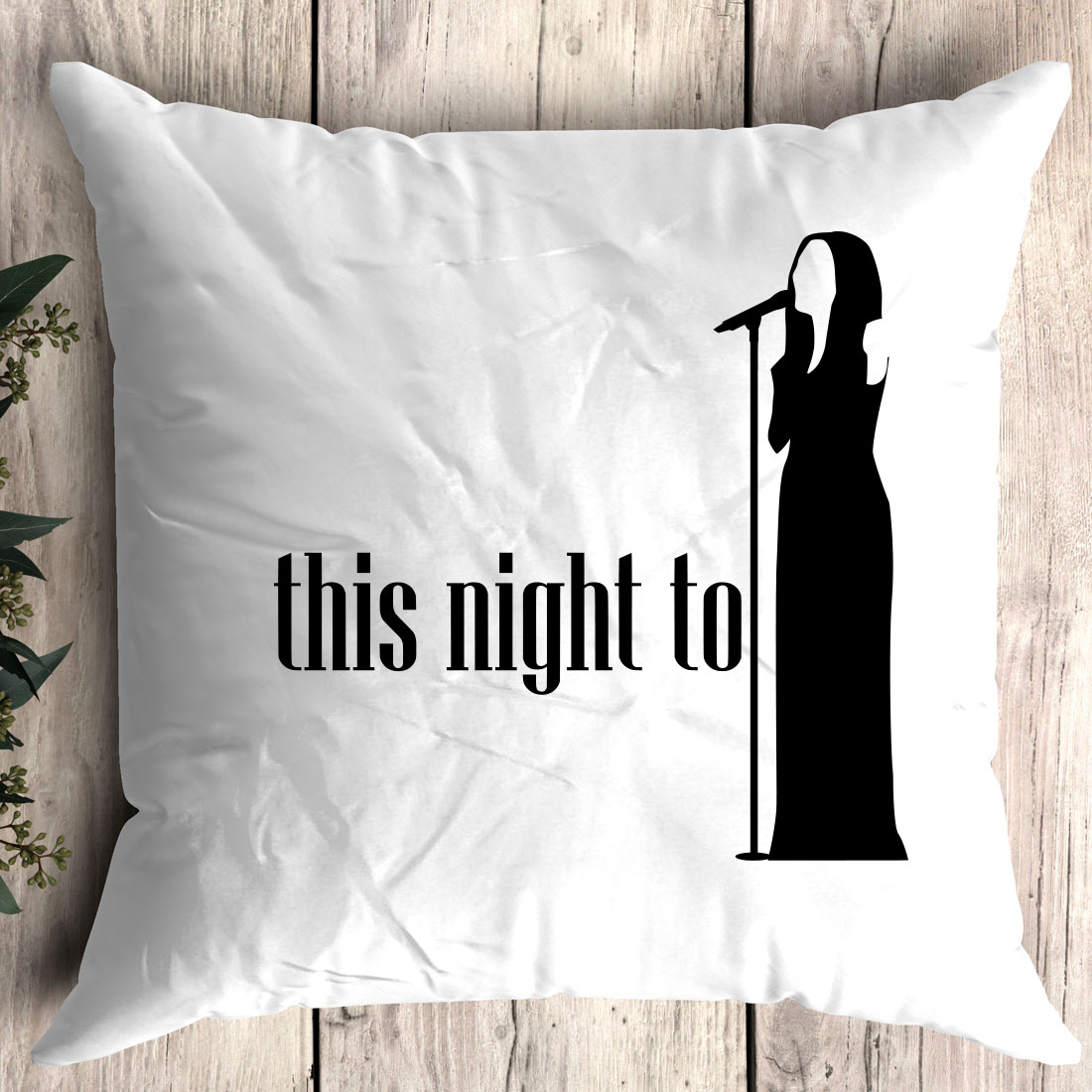 White pillow with a black silhouette of a woman singing into a microphone.