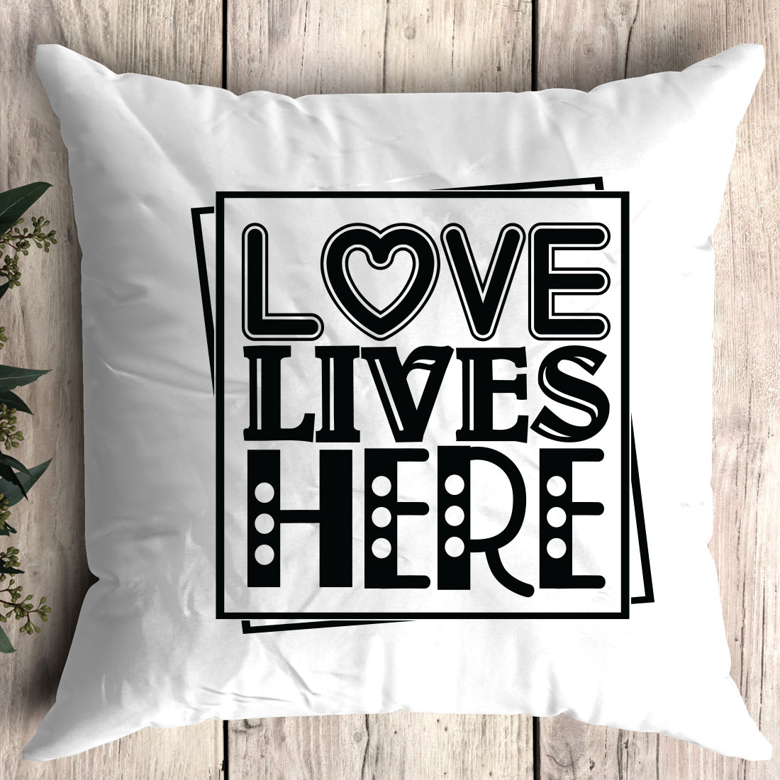 White pillow with the words love lives here on it.