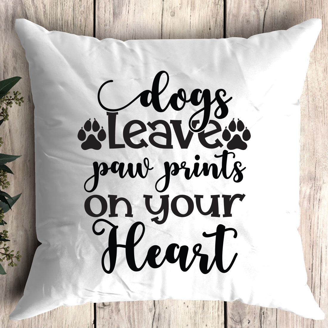 Pillow that says dogs leave paw prints on your heart.