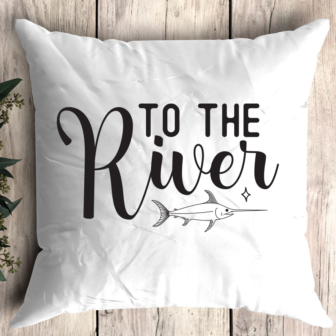 White pillow with the words to the river printed on it.