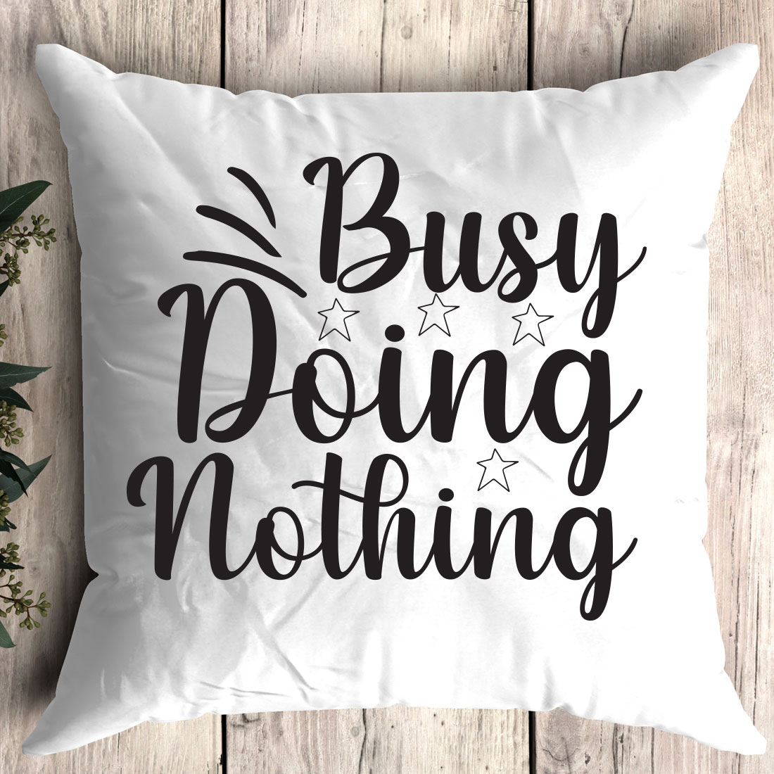 Pillow that says busy doing nothing on it.