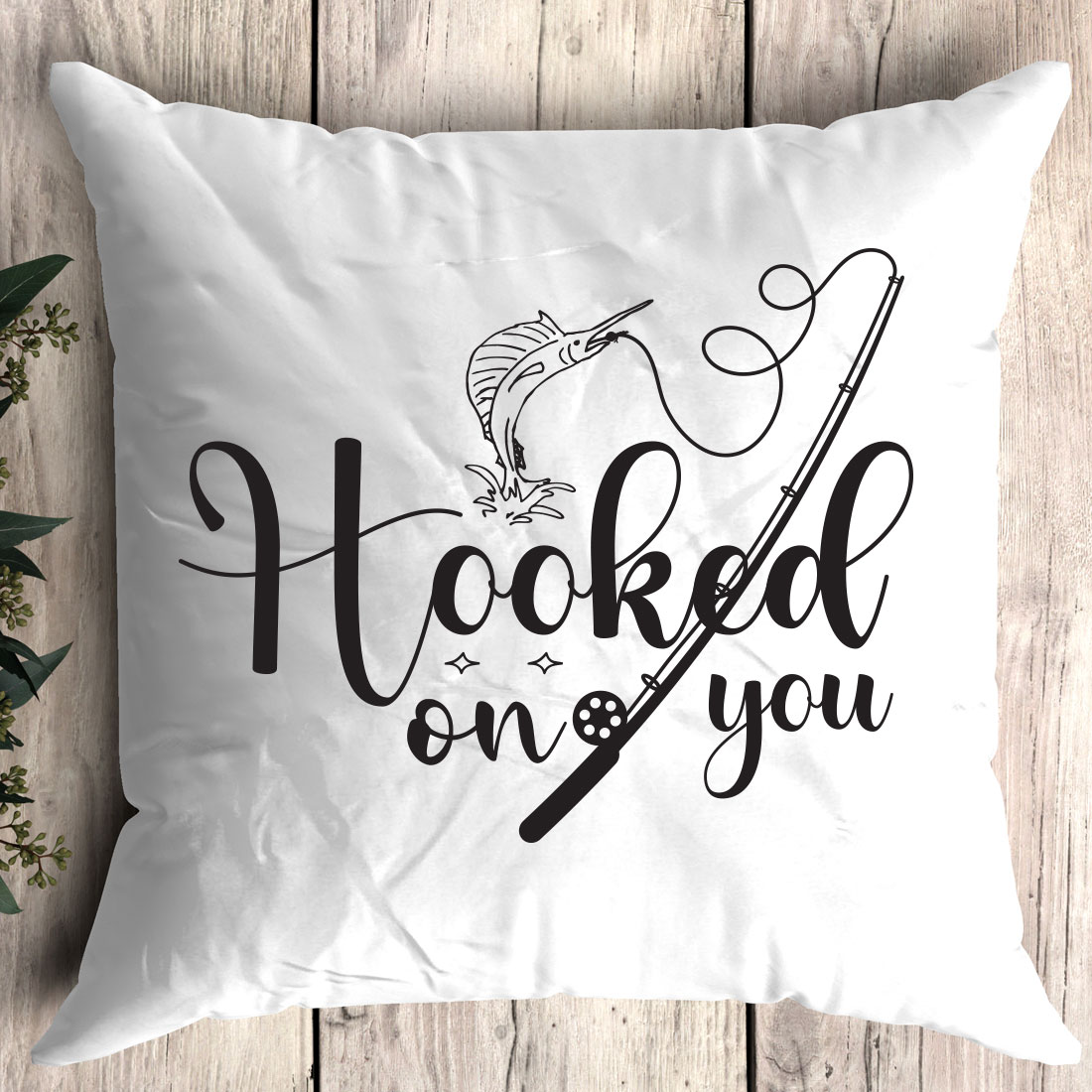 White pillow with the words hooked on you printed on it.
