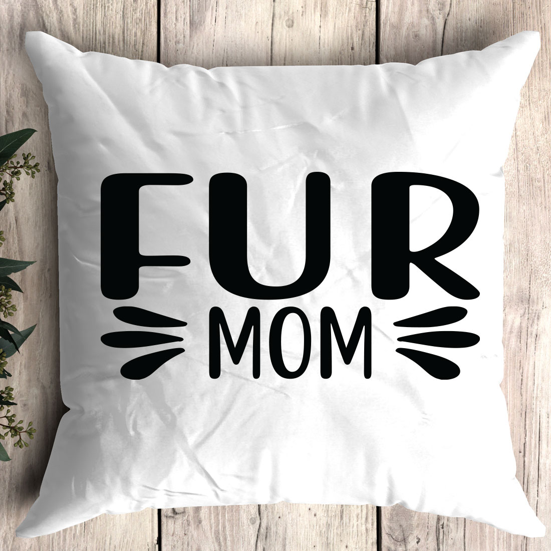 White pillow with the words fur mom printed on it.