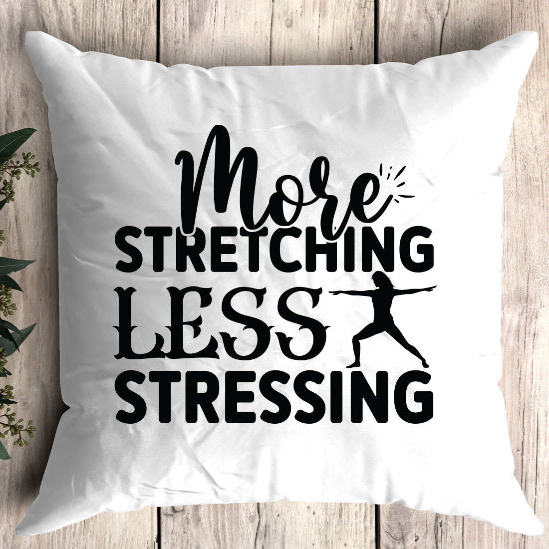 White pillow that says more stretching less stressing.