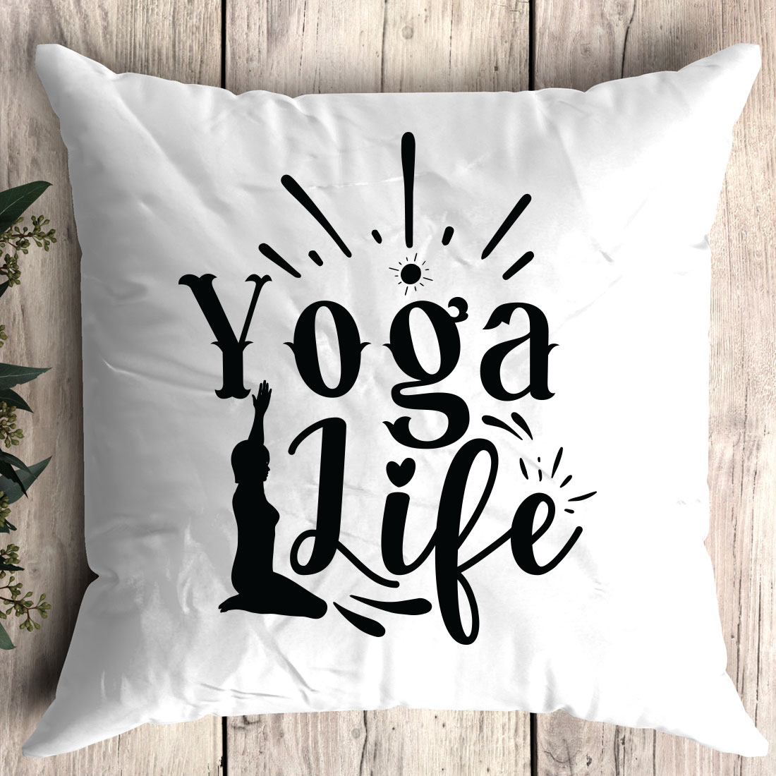 White pillow with the words yoga life printed on it.