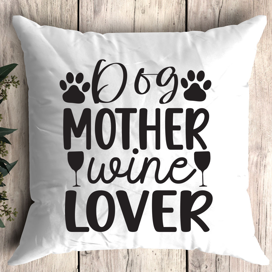 White pillow that says dog mother wine lover.