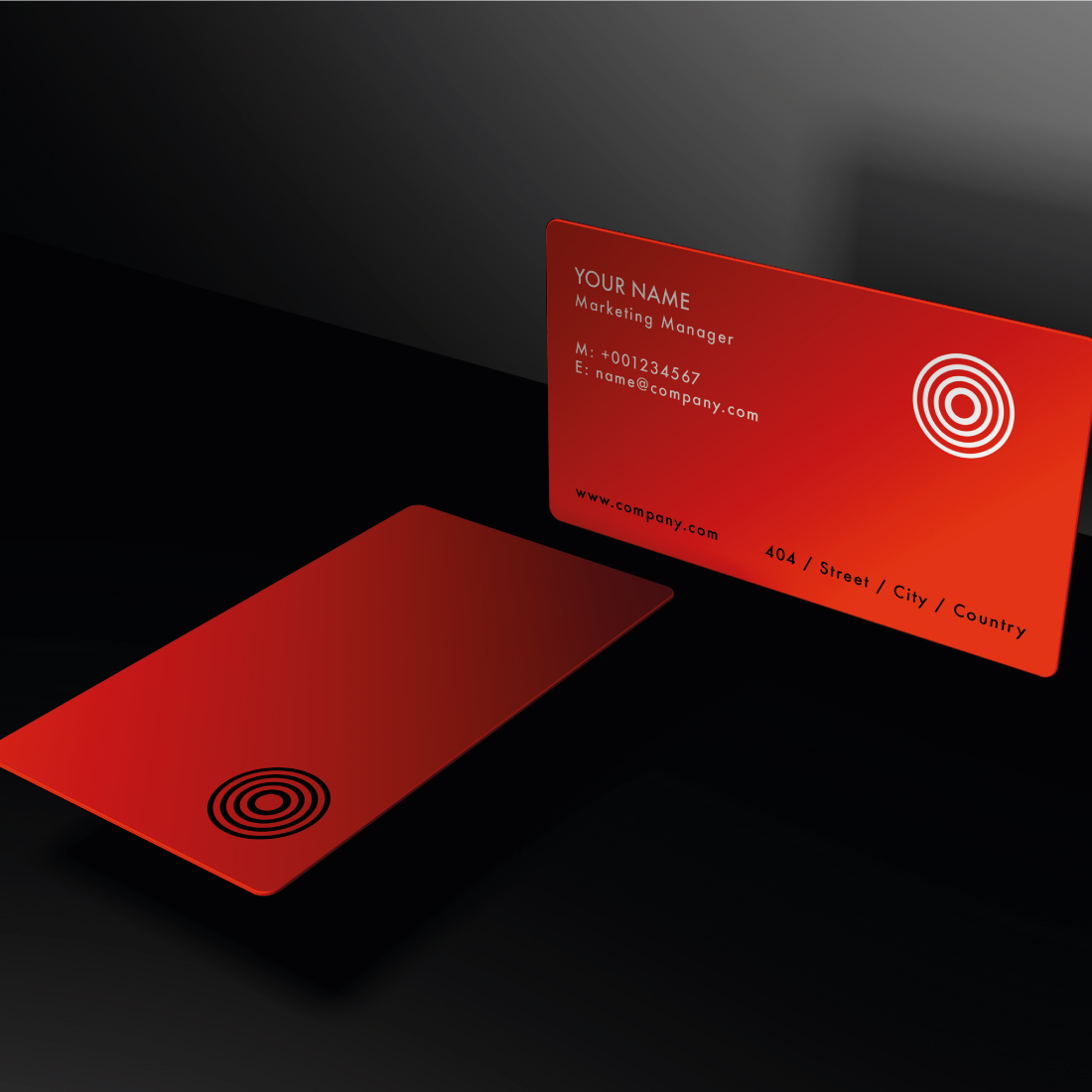 Red business card sitting on top of a black table.