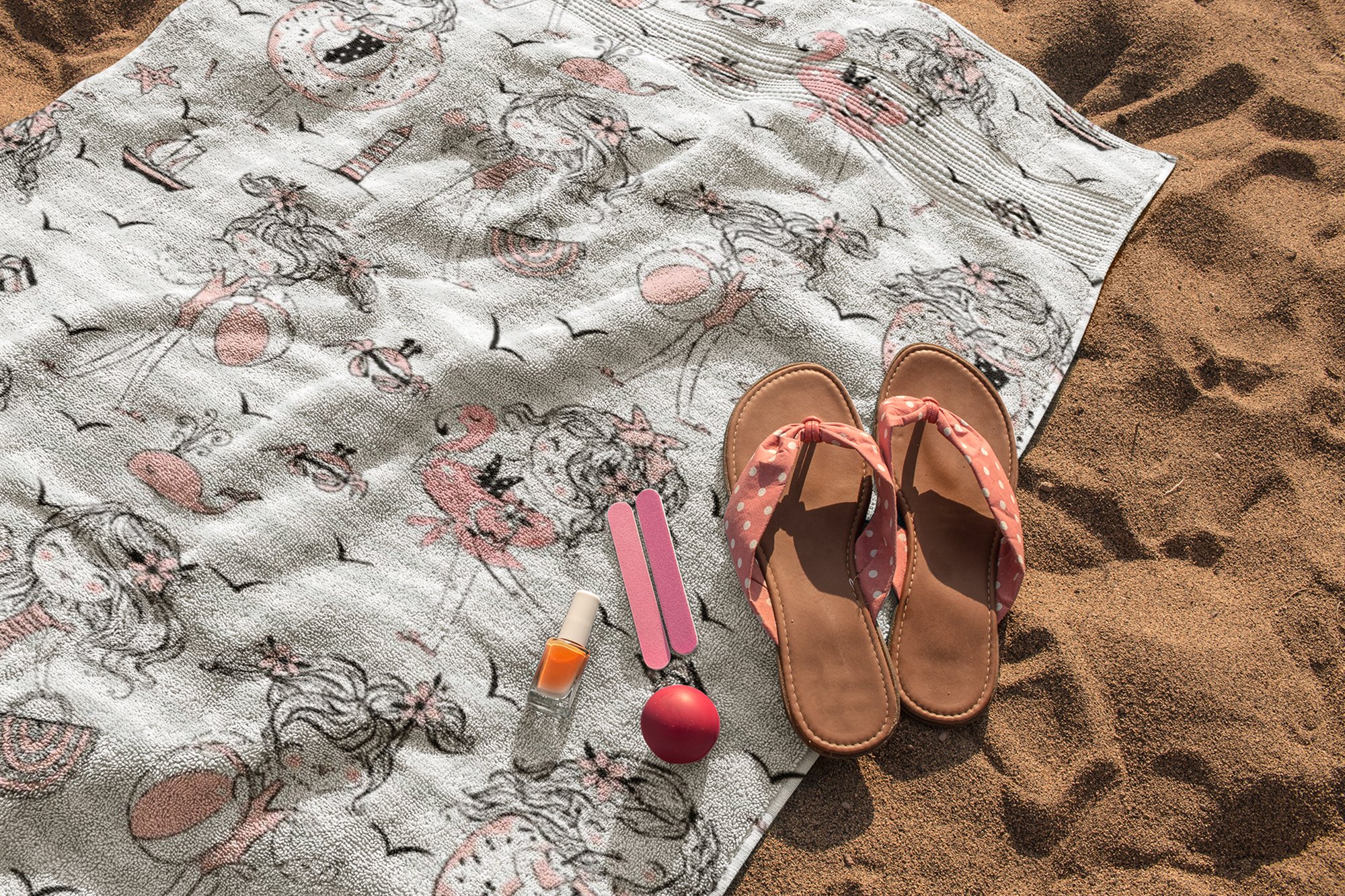 beach towel mockup lying on the sand with sandals and accessories on it a14890 410