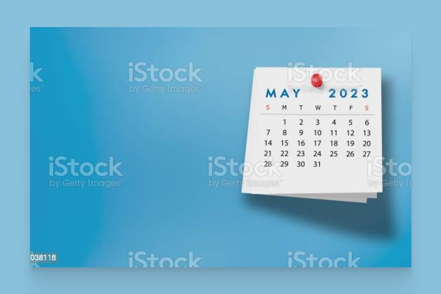 2023 May Calendar on Note Pad Against Blue Background stock photo.