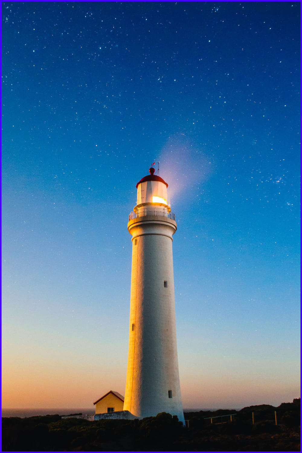 View of the lighthouse against the sunset sky.