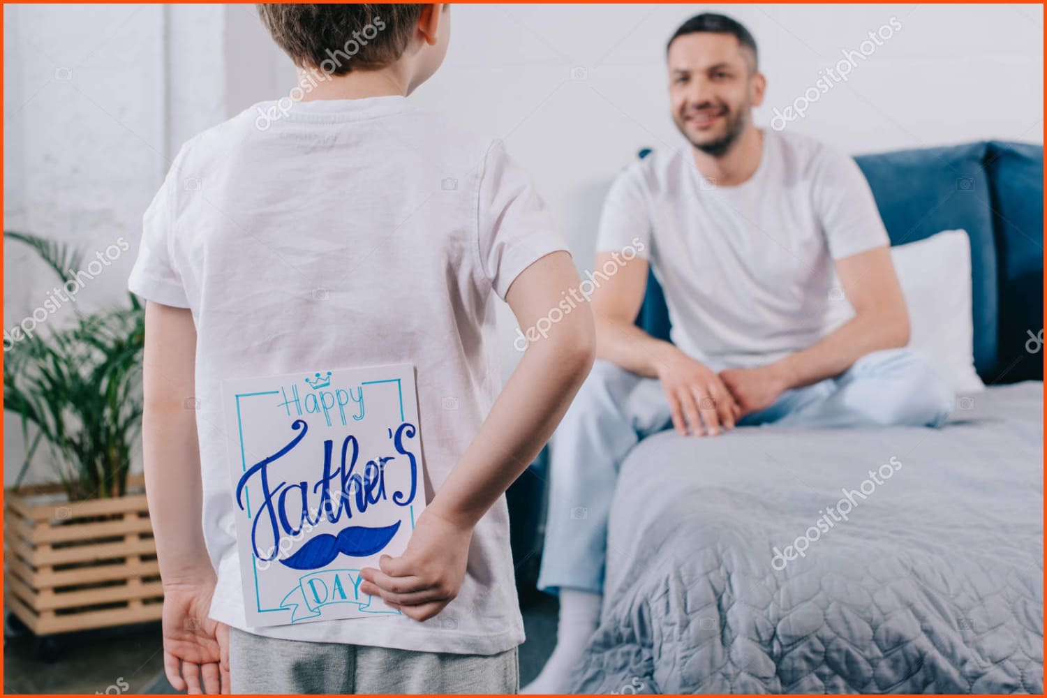 Child holding fathers day card.