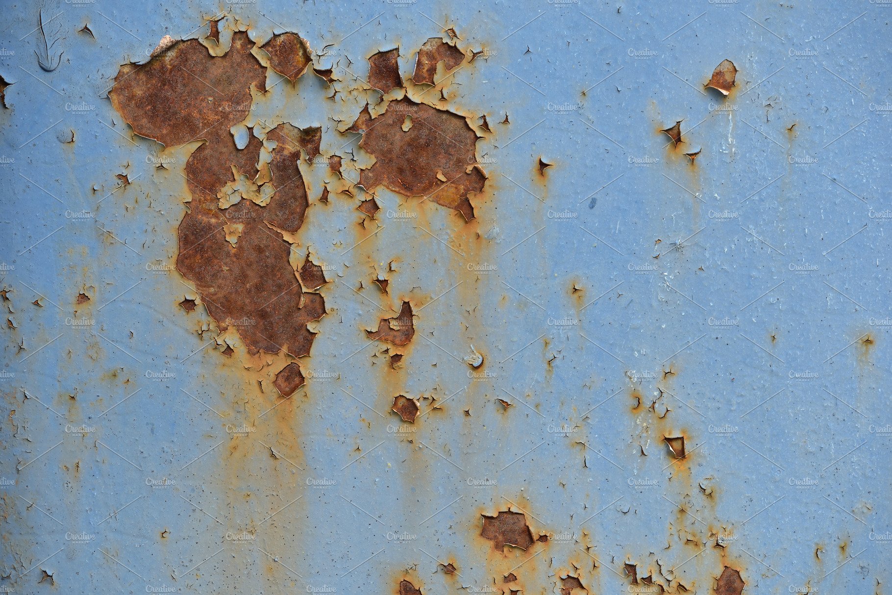 Photo of an old rusty wall with blue cover image.