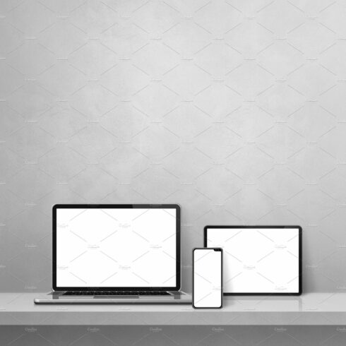 Laptop, mobile phone and digital tablet pc on grey wall shelf. V cover image.