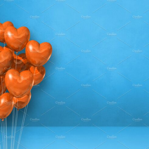 Orange heart shape balloons bunch on a blue wall background. Hor cover image.