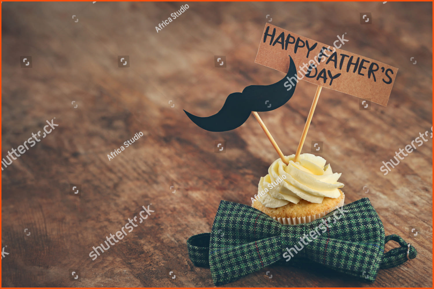 Happy fathers day special cupcake and tie on wooden table.