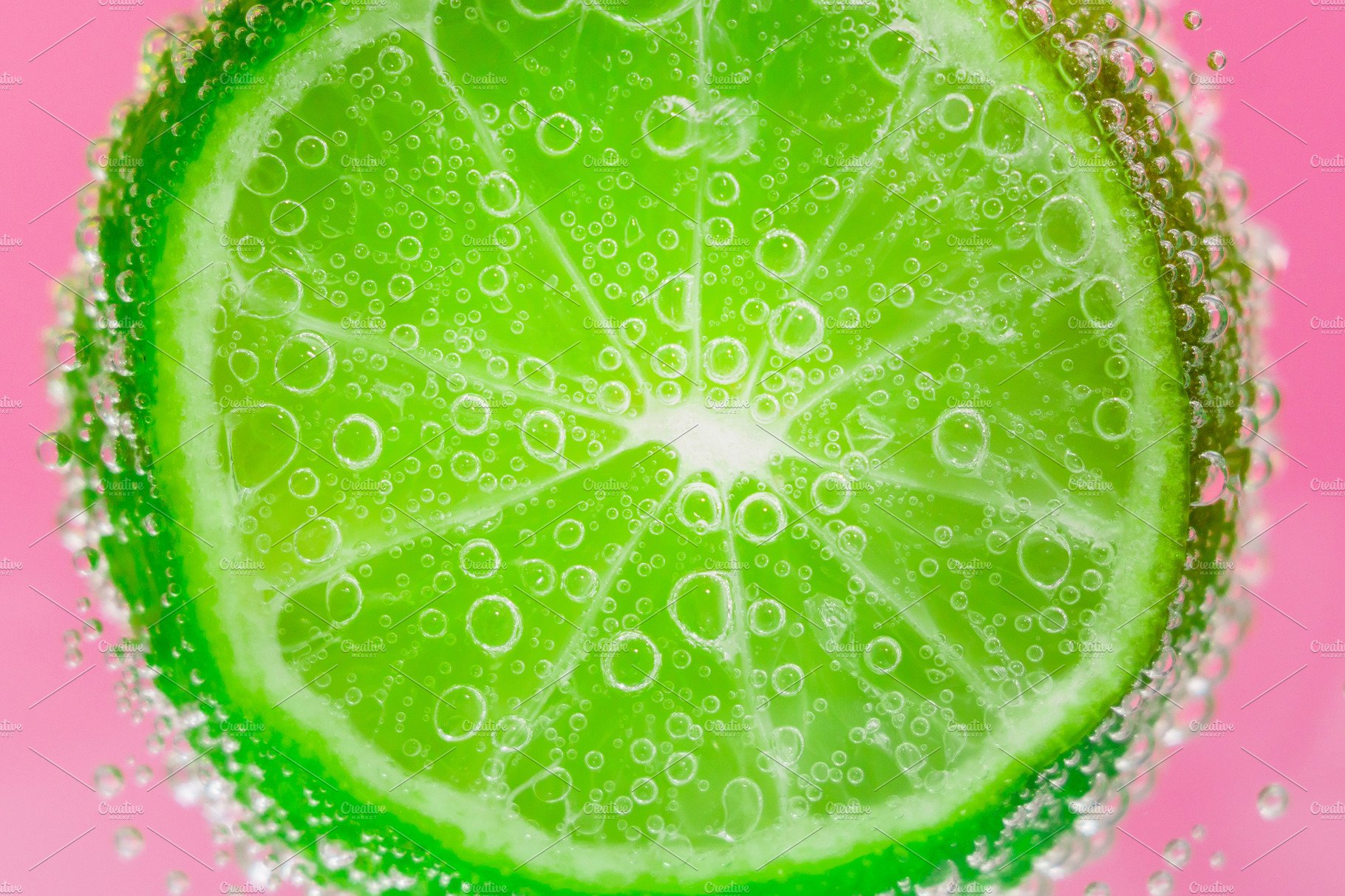 lime fruits in water under water cover image.