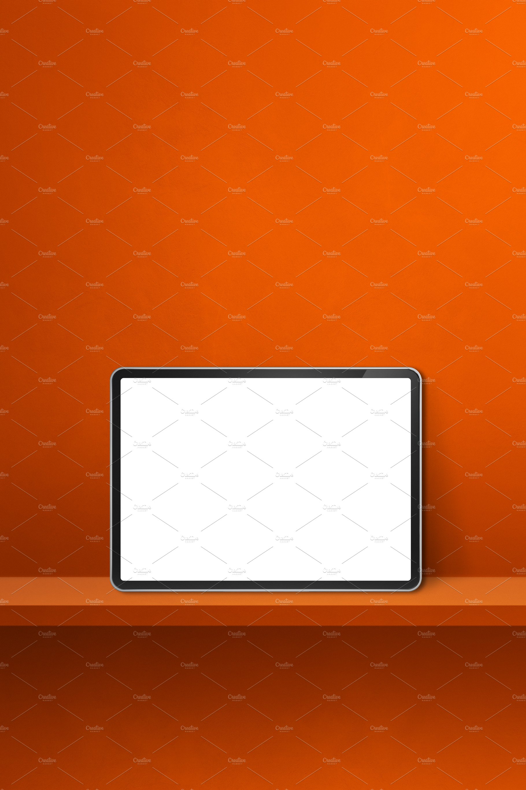 Digital tablet pc on orange wall shelf. Vertical background bann cover image.