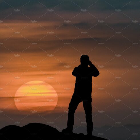 Man Taking Photos at Sunset cover image.