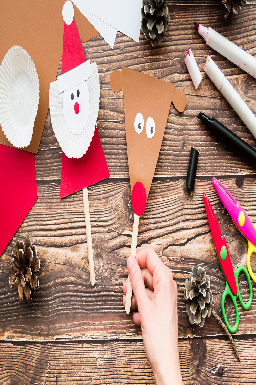 Closeup woman's handholding props made with paper wooden pinterest preview image.