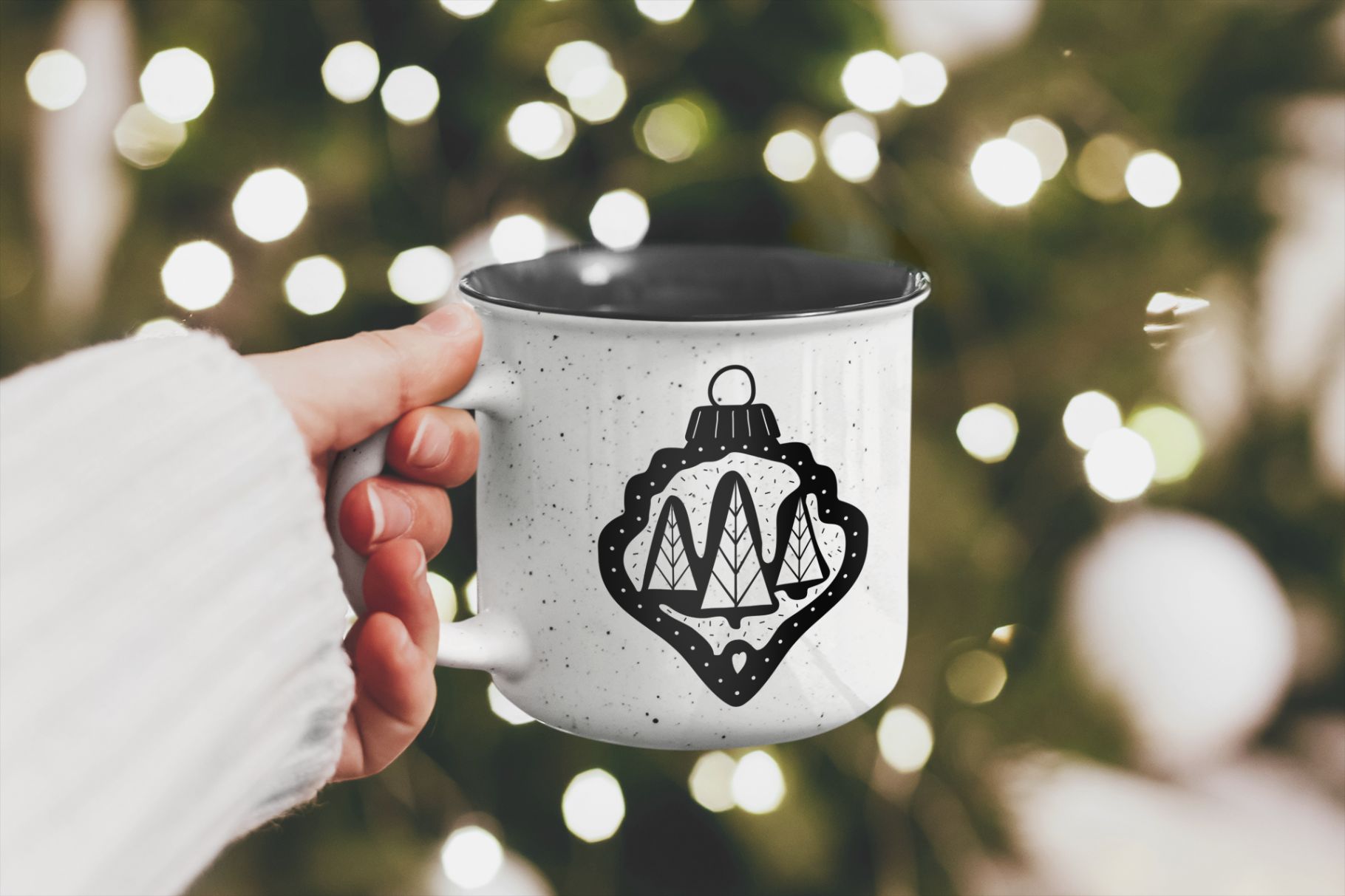 mockup of a woman holding a 12 oz enamel mug on christmas with christmas toy black silhouette print design 568