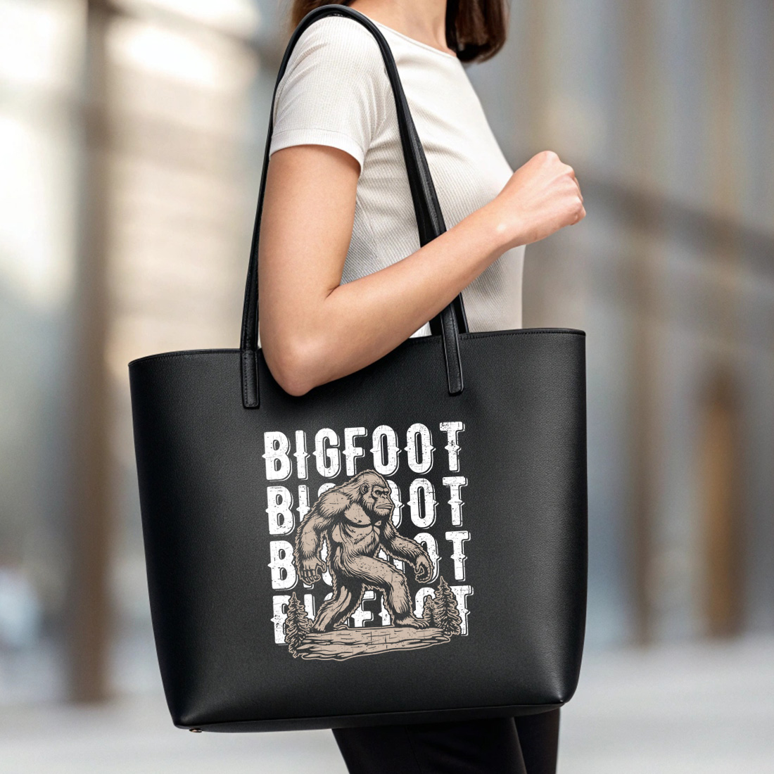 vintage bigfoot t shirt design with distressed text and forest background 6 black tote beg mock up 288