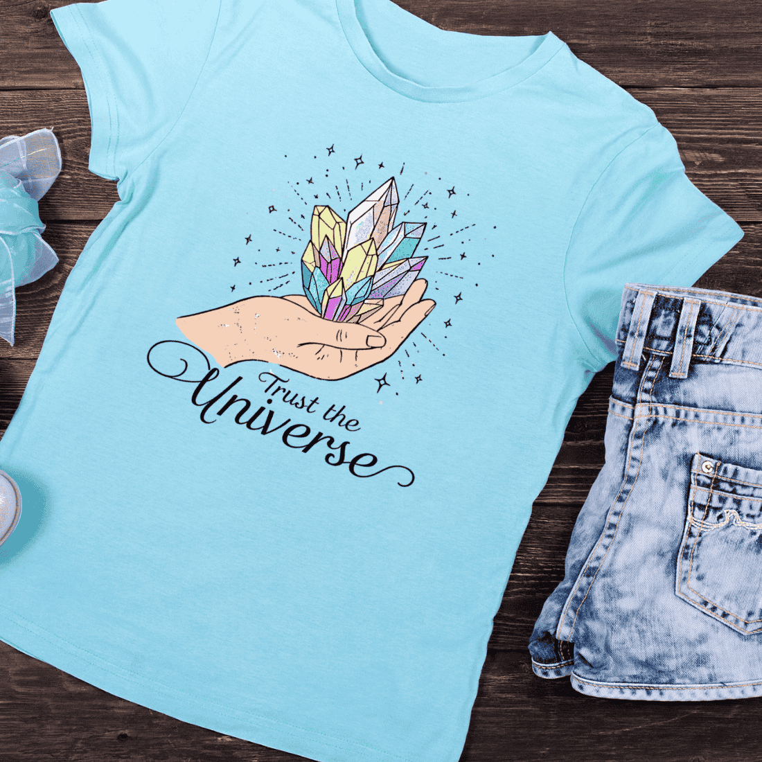 Hand Holding Colorful Crystals Trust the Universe T-Shirt Design preview image.