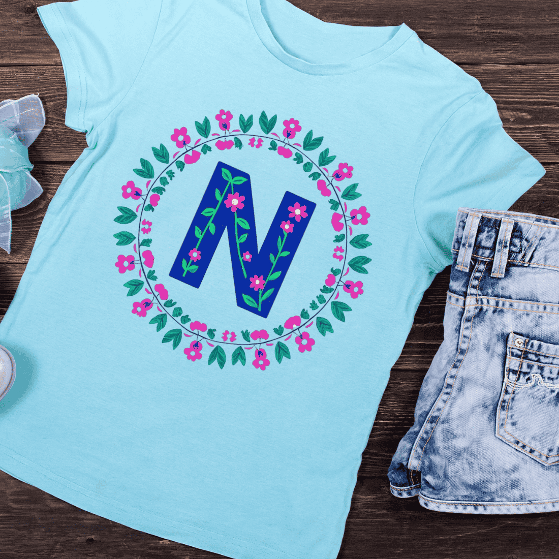 Hand-Drawn Style N in Floral Round Frame T-Shirt Design preview image.