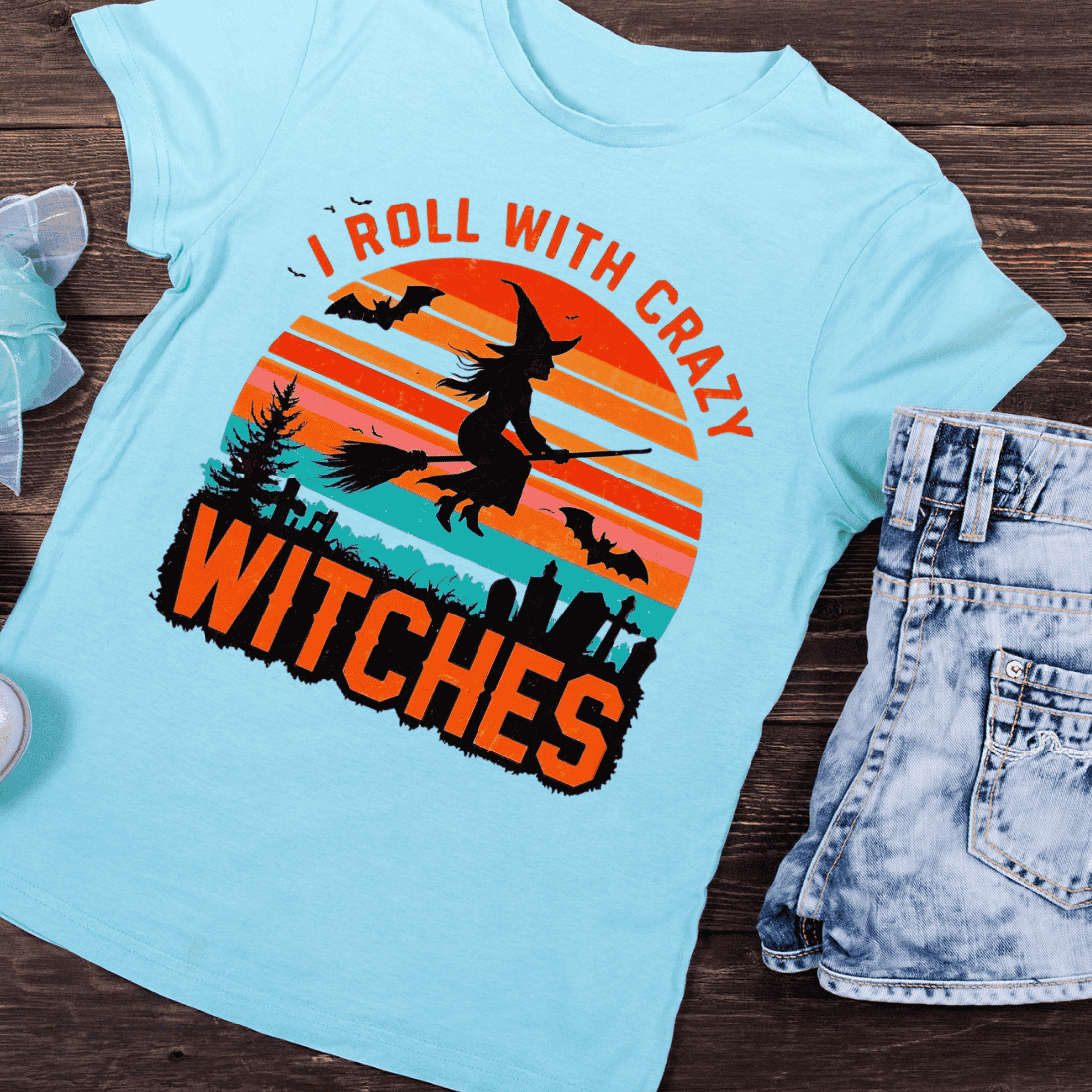 Spooky Sunset with Witch Silhouette T-Shirt Design preview image.