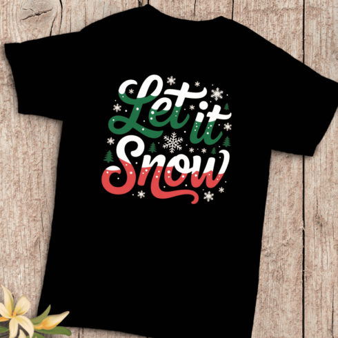 Festive Let It Snow Winter Holiday Typography T-Shirt Design cover image.