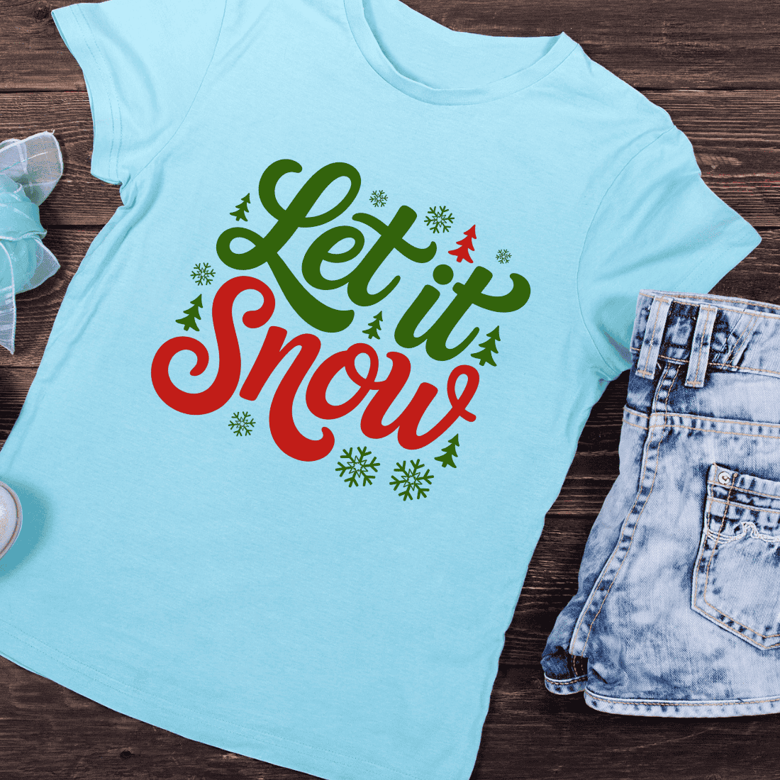 Let It Snow Lettering with Snowflakes and Trees T-Shirt Design preview image.