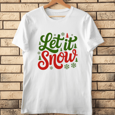 Let It Snow Lettering with Snowflakes and Trees T-Shirt Design cover image.