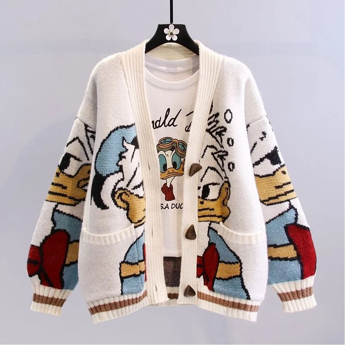 The women’s oversized thick knitted cardigan with cartoon print cover image.