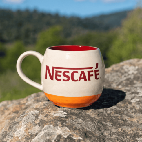Cream Orange Red Round Mug Duo – Stylish Coffee & Tea Cups with Nescafé Branding cover image.