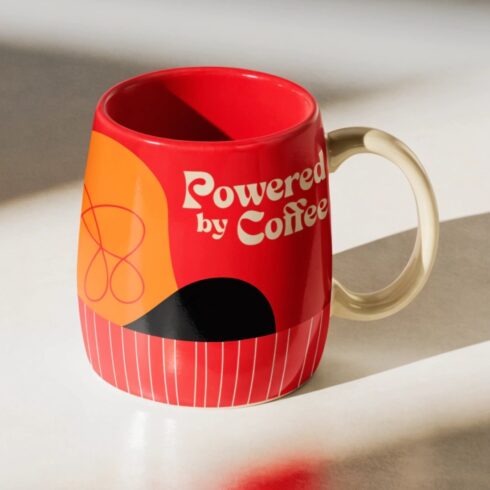 Modern Powered by Coffee Mug Mockup Pair | Cream Mug with Red Handle cover image.